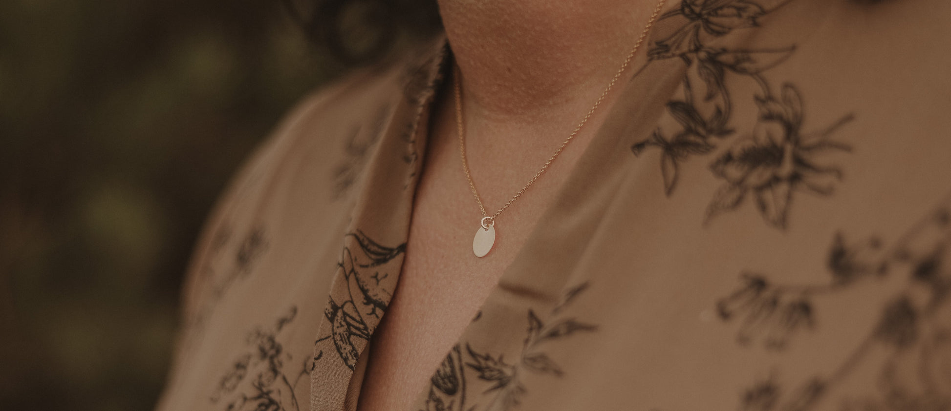 Modell trägt die Kette PLAQUETTE mit goldenem Plättchen-Anhänger, elegantes Accessoire für verschiedene Anlässe